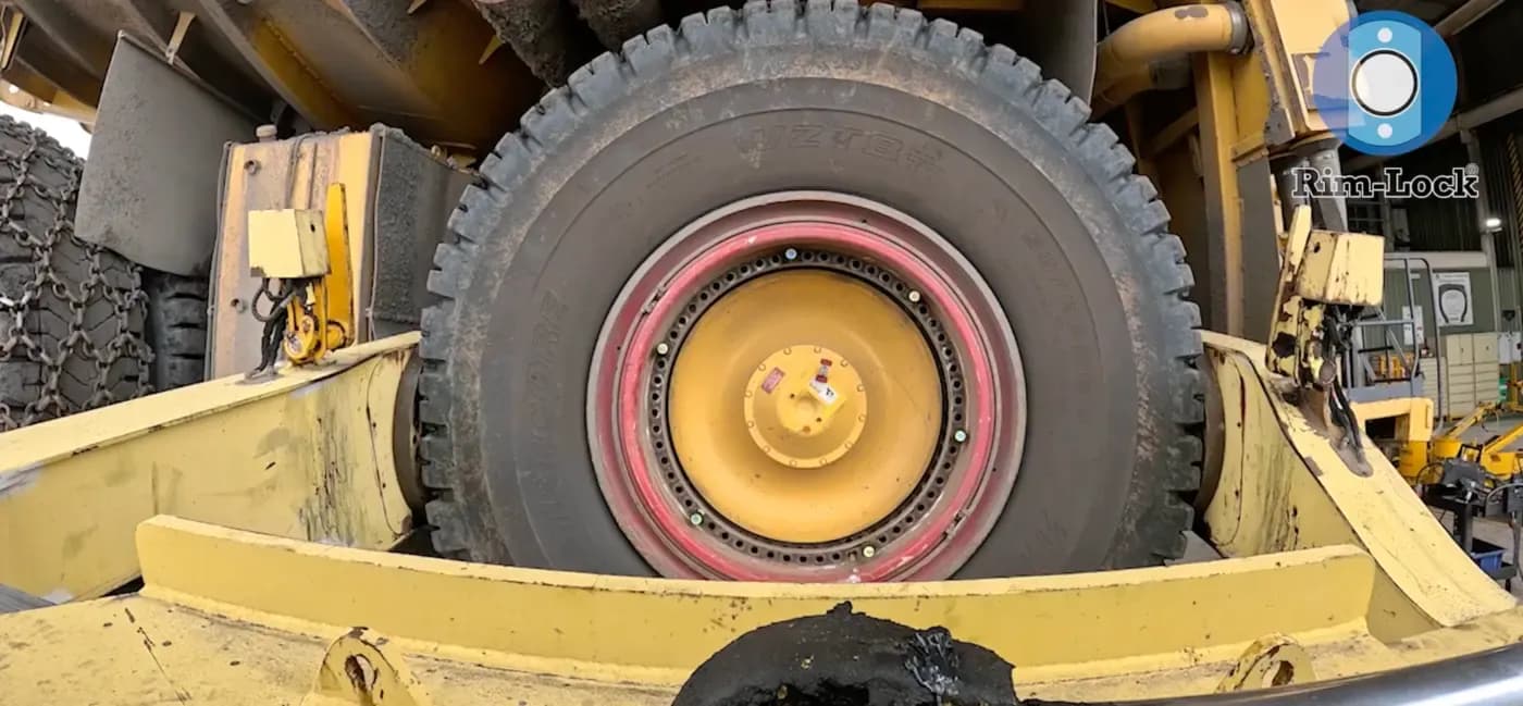 A truck wheel assembly being fitted to the hub with Rim-Lock® retainers in place