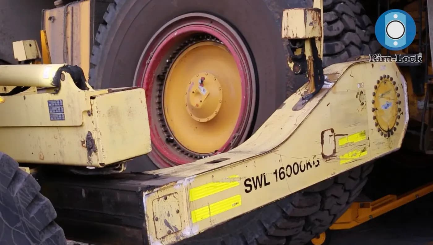 A haul truck wheel assembly marked with its 16,000 safe working load
