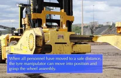 The tyre handler moving into position once all personnel are at a safe distance